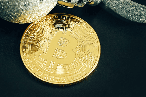 What is KYC and Why is it Required on Crypto Exchanges? A single Bitcoin with silver Christmas balls